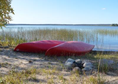photo from Pinehouse of canoes by lake